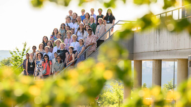 Gruppenfoto von Teilnehmenden eines ct.qmat-Workshops auf einer Außentreppe, sommerliche Atmosphäre.